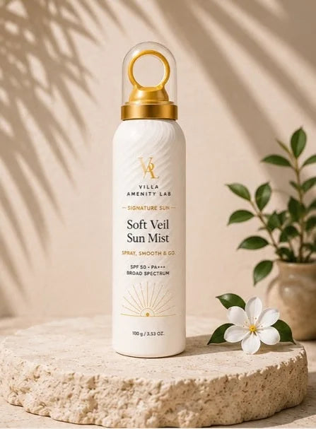 Soft Veil Sun Mist 150g bottle on travertine with palm shadow
